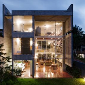 3-Storey Wall of Books Creates Privacy for Contemporary Home